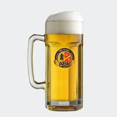 a ABK beer tankard full of beer on a plain background