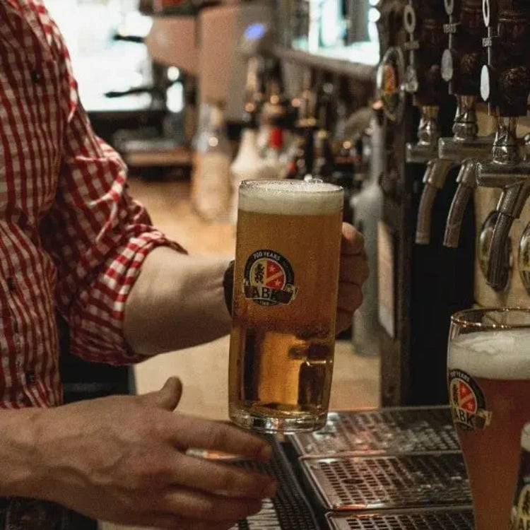 Bartender holding an abk german beer stein glass