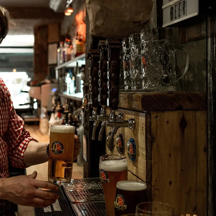 A bartender serving abk edel german beer