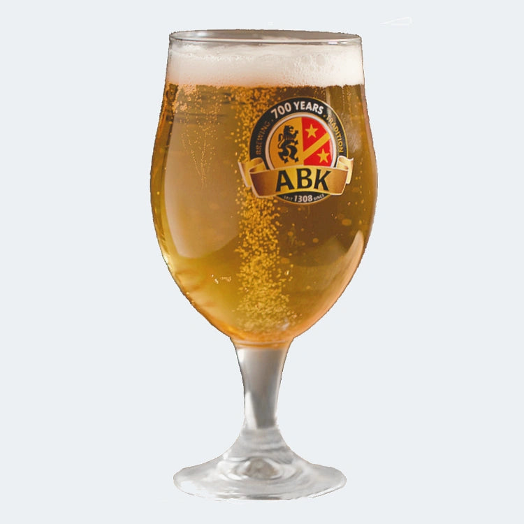 A german munique glass with abk pilsner on a plain background