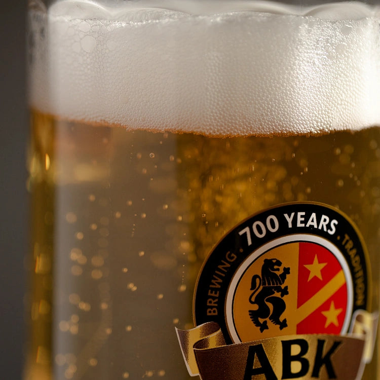 A close up shot of a abk stein with beer in it
